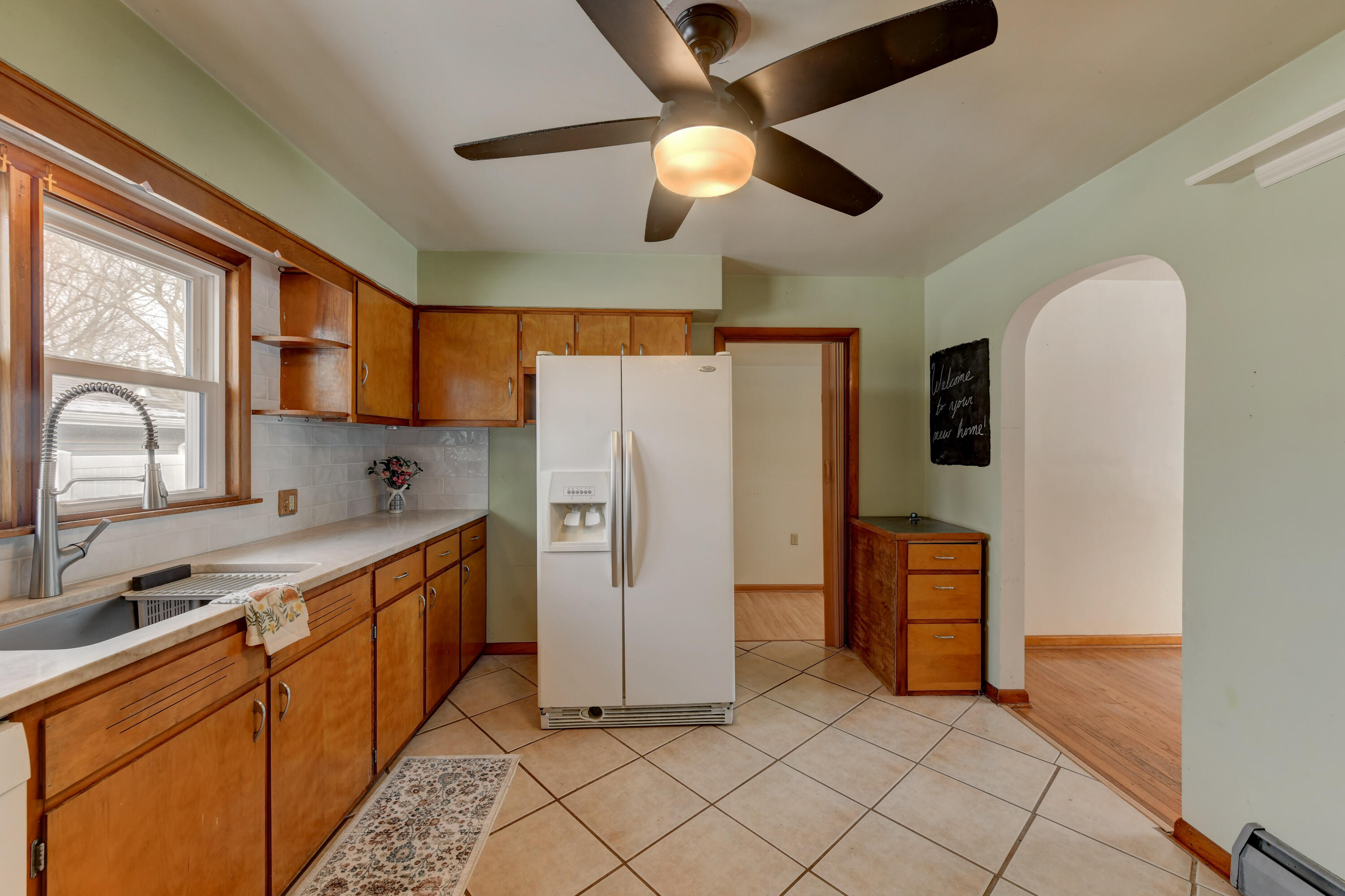 9046 Kleinman Road Highland, IN 46322 - Photo 8 of 20 a kitchen with stainless steel appliances granite countertop a refrigerator a sink dishwasher a stove with wooden cabinets and floor