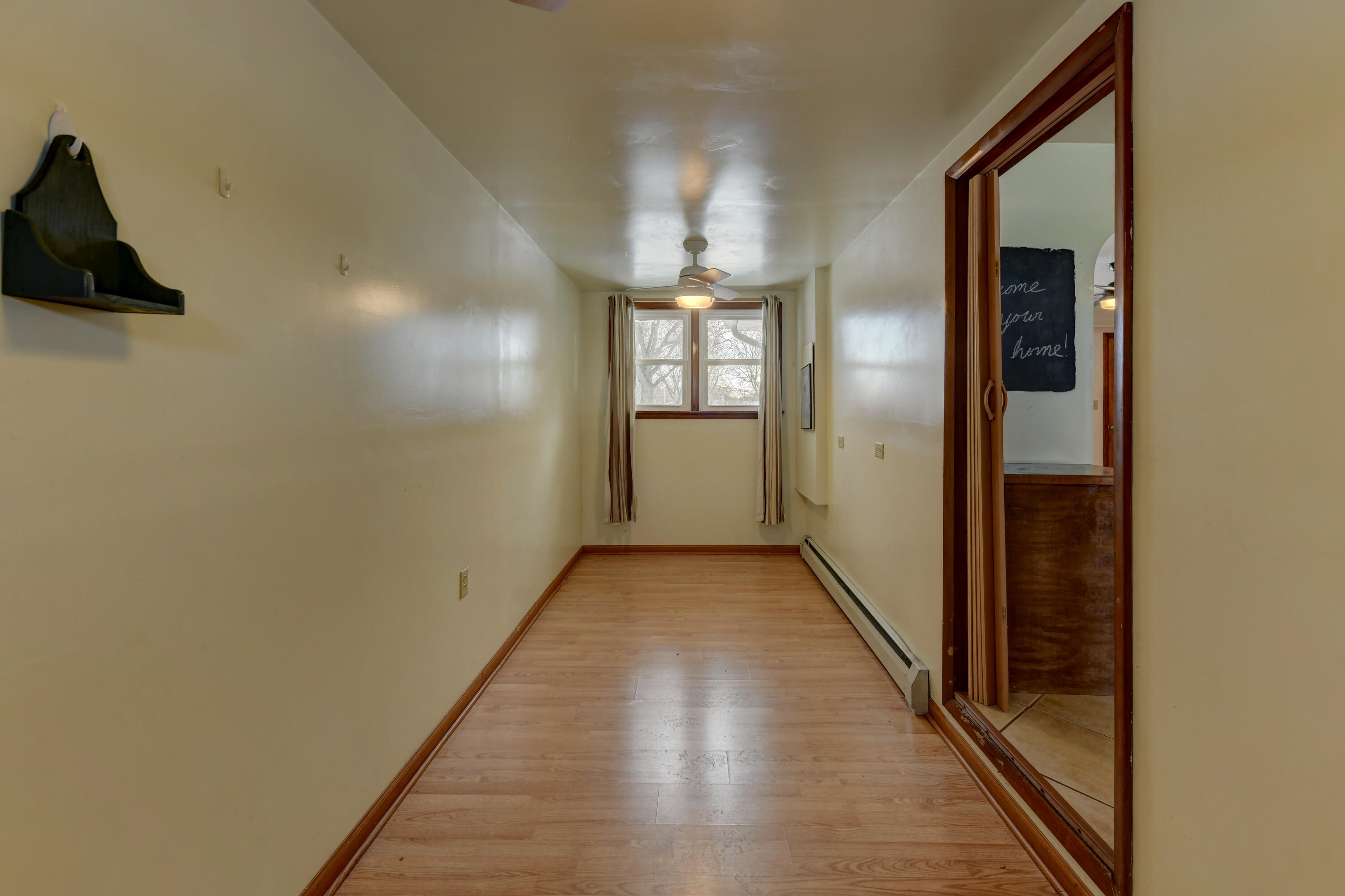 9046 Kleinman Road Highland, IN 46322 - Photo 10 of 20 a view of a hallway with wooden floor and a bathroom