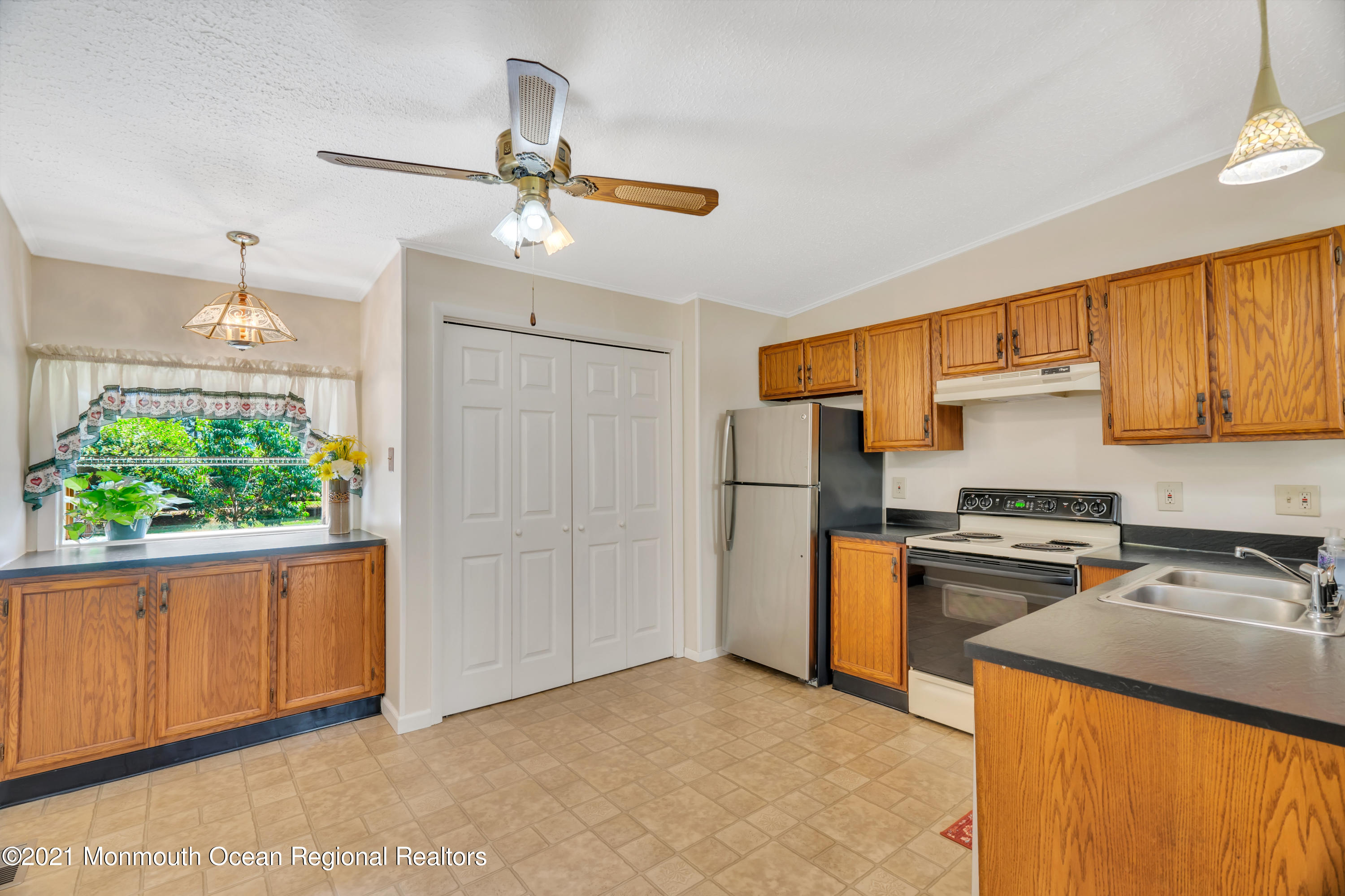 447 Leming Road Jackson, NJ 08527 - Photo 11 of 71 a kitchen with stainless steel appliances granite countertop a refrigerator a sink dishwasher a stove with wooden cabinets and floor
