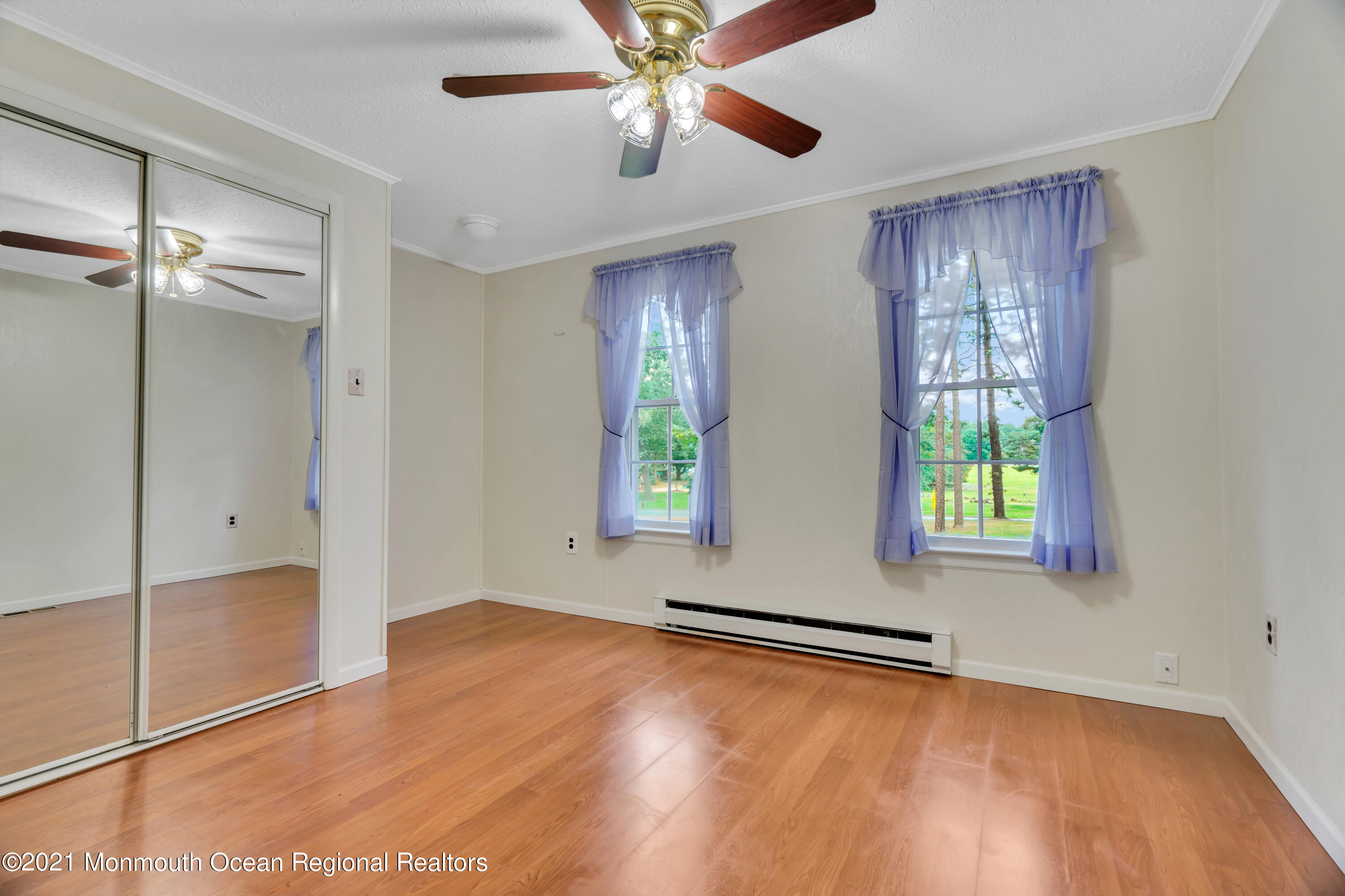 447 Leming Road Jackson, NJ 08527 - Photo 22 of 71 a view of an empty room with window and wooden floor