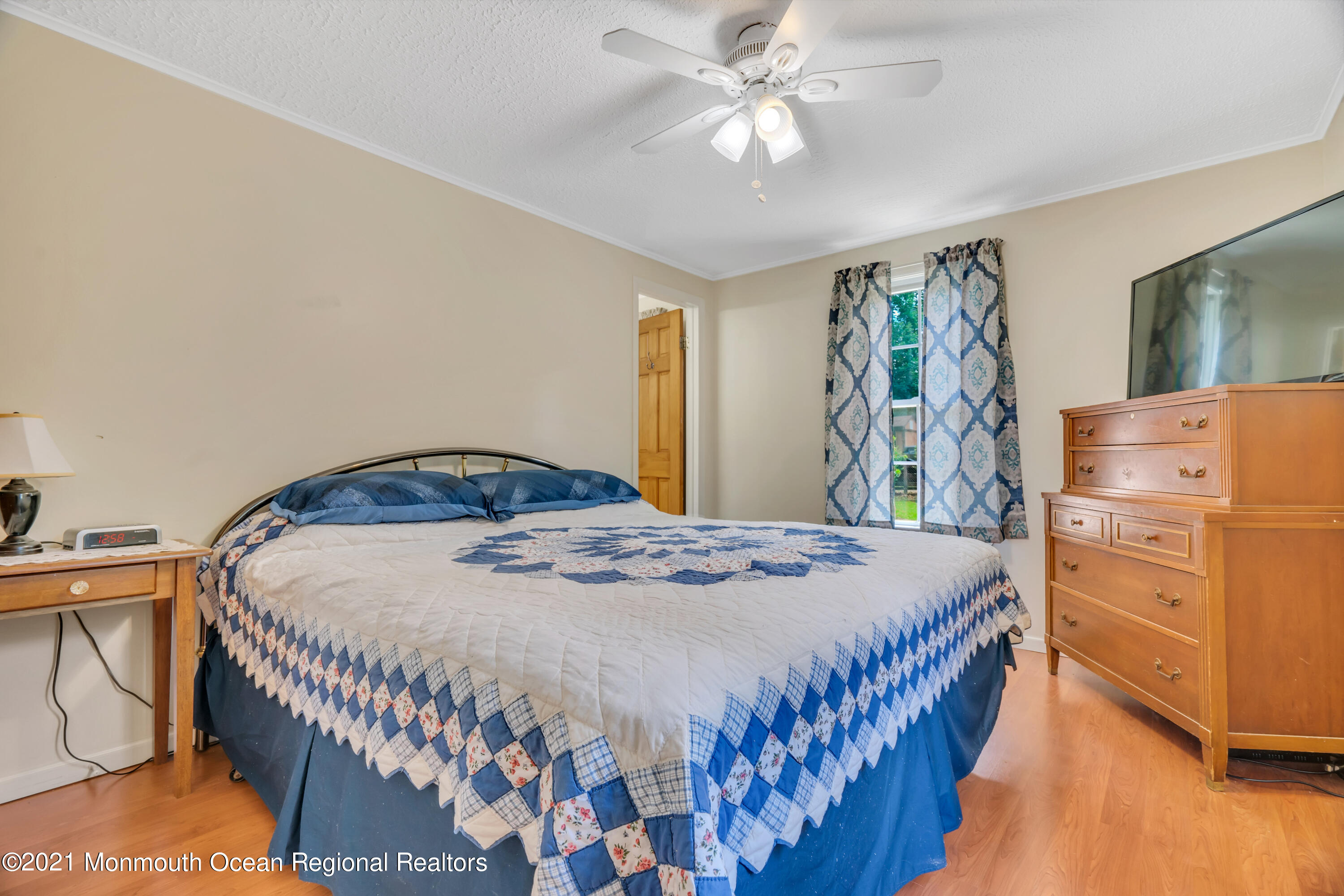 447 Leming Road Jackson, NJ 08527 - Photo 25 of 71 a bedroom with a bed and a chandelier