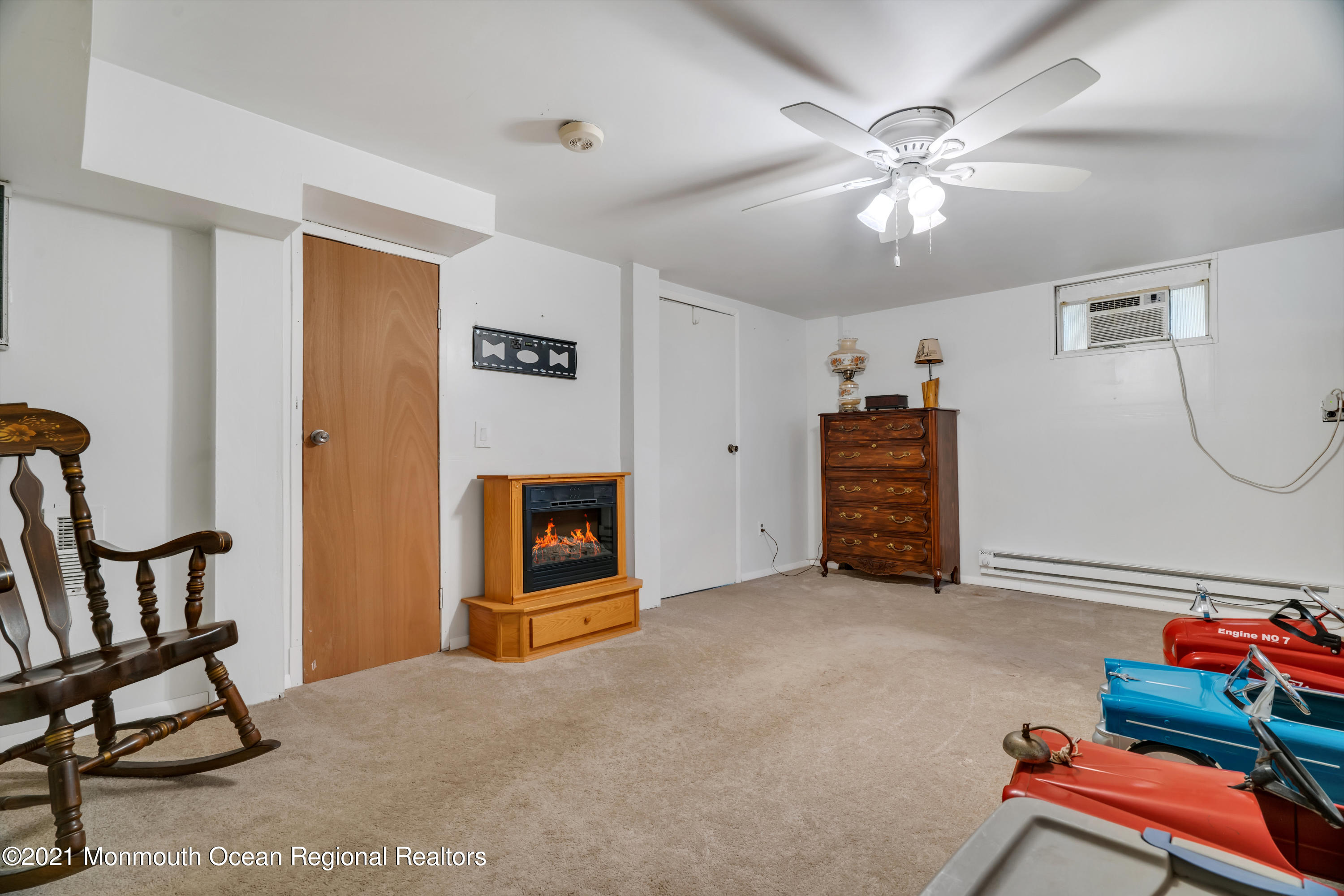 447 Leming Road Jackson, NJ 08527 - Photo 43 of 71 a view of an empty room with furniture and a chandelier fan