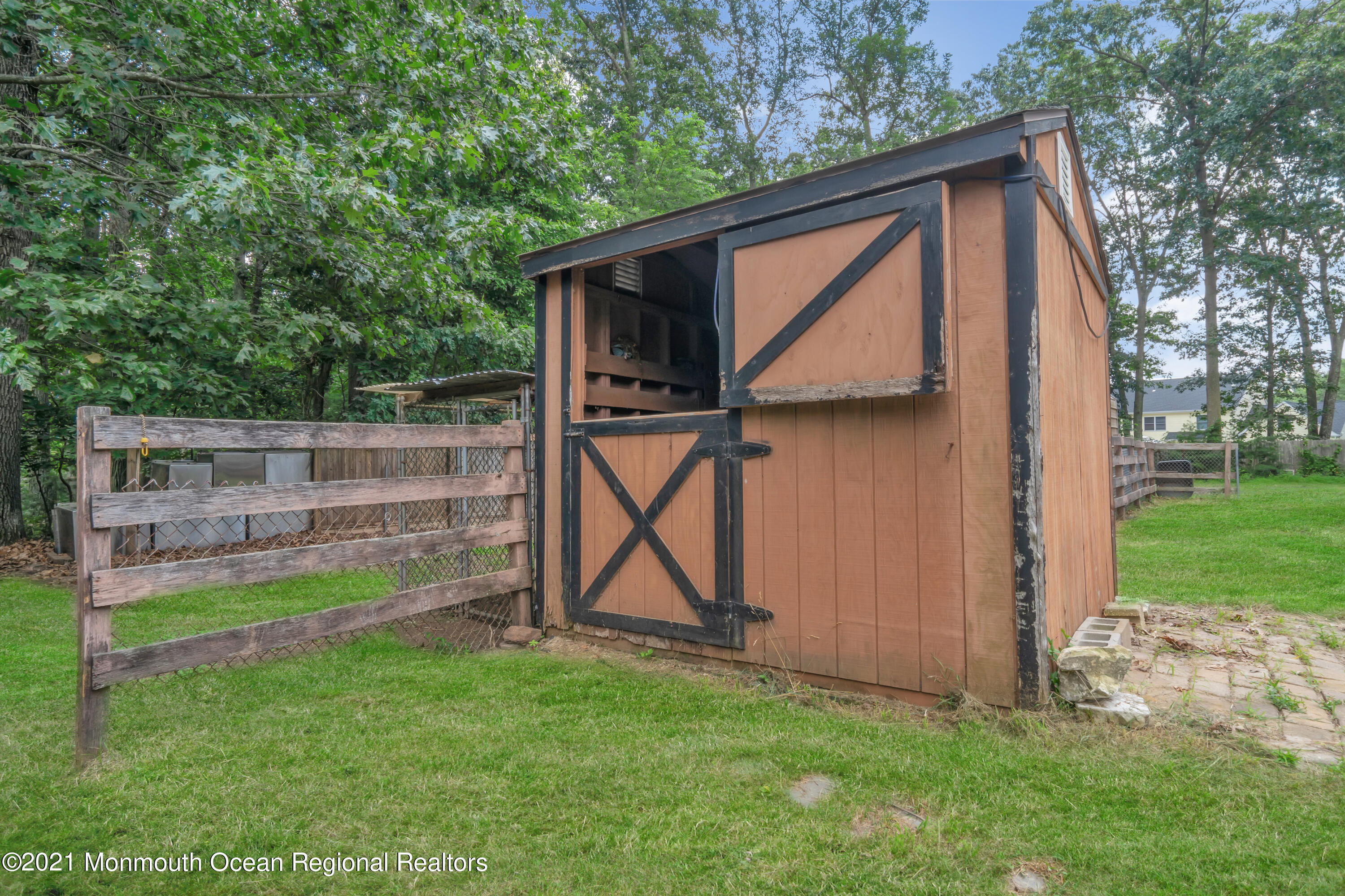 447 Leming Road Jackson, NJ 08527 - Photo 55 of 71 a view of backyard with wooden fence and a bench