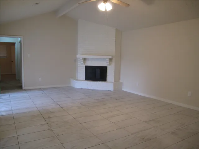 an empty room with a empty space and a chandelier fan