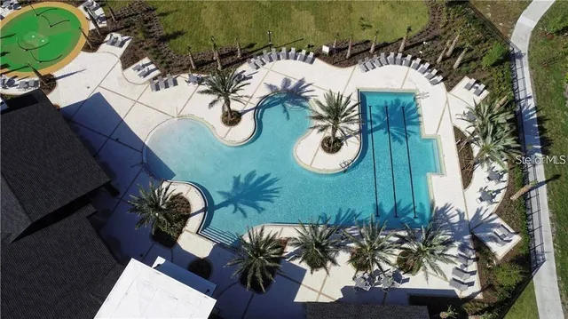 a swimming pool with outdoor seating yard and barbeque oven