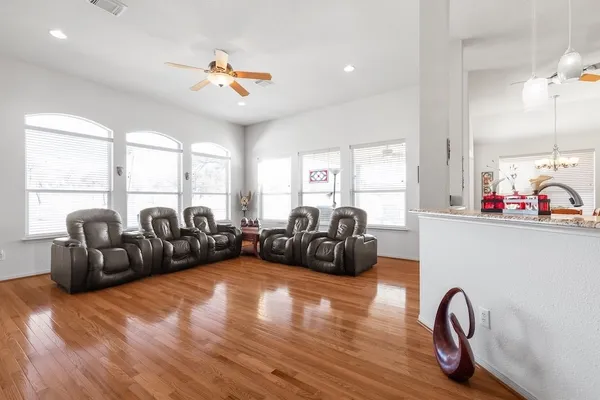 a living room with furniture gym equipment and a large window