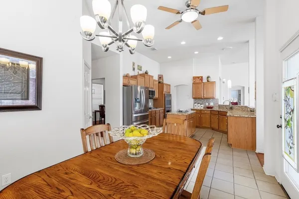 a view of a dining room and kitchen with a table chairs and chandelier