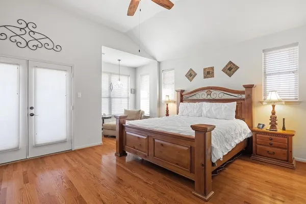 a bedroom with a bed and a window