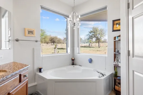 a white bath tub sitting next to a white sink