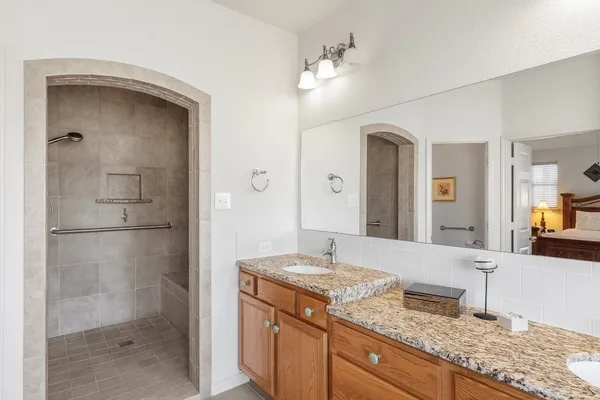 a bathroom with a granite countertop sink and a mirror