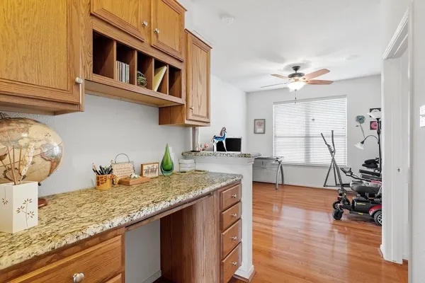 a kitchen with granite countertop a table chairs stove and cabinets