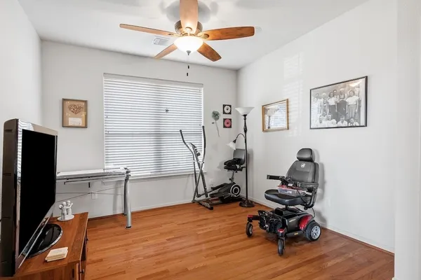 a view of a workspace with furniture and a window