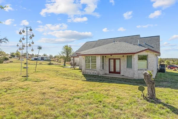 a view of a house with swimming pool and sitting area