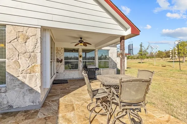 a dining room with furniture and a floor to ceiling window
