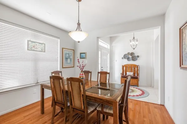 a view of a dining room with furniture wooden floor and a chandelier