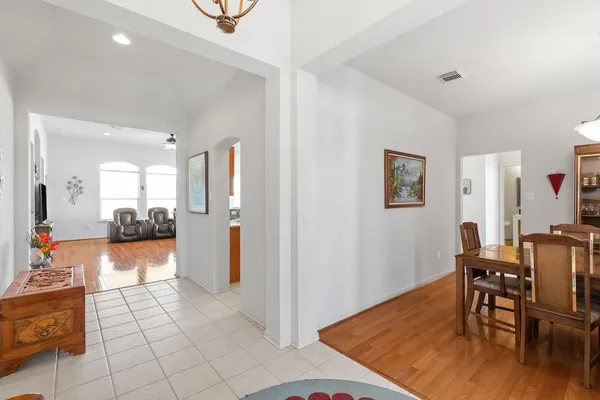 a view of a livingroom with furniture and a kitchen view
