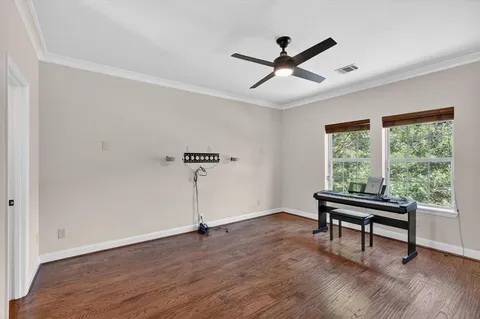 a view of a workspace with wooden floor and a window