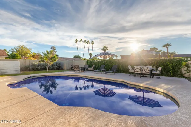 a view of a swimming pool with a yard