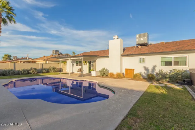 a view of a swimming pool with a lounge chair