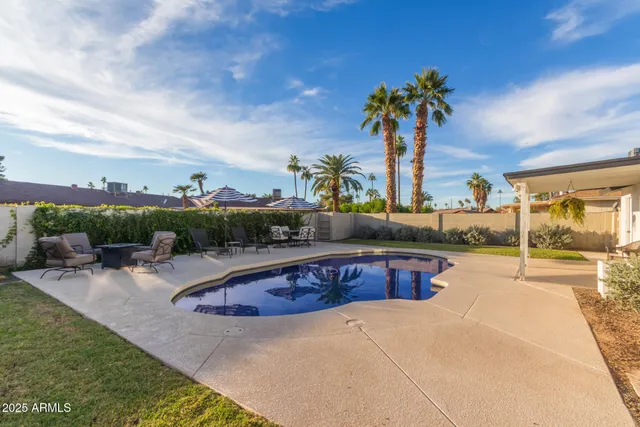 a swimming pool with outdoor seating