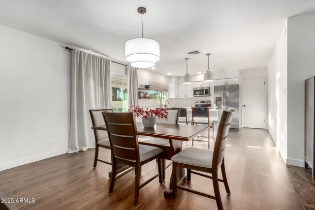 a view of a dining room with furniture window and wooden floor