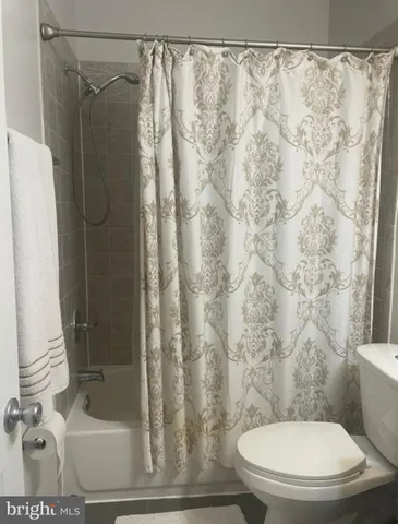 a bedroom with a bed and a night stand