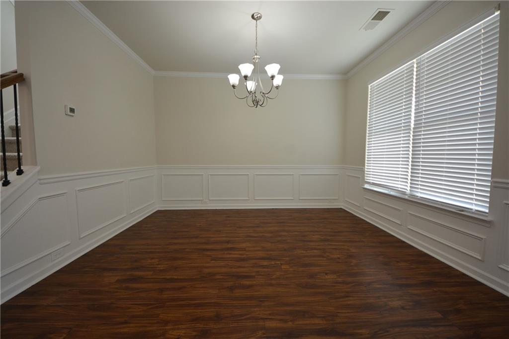 2330 Haliard Way Lithonia, GA 30058 - Photo 9 of 38 a view of an empty room with wooden floor and a window
