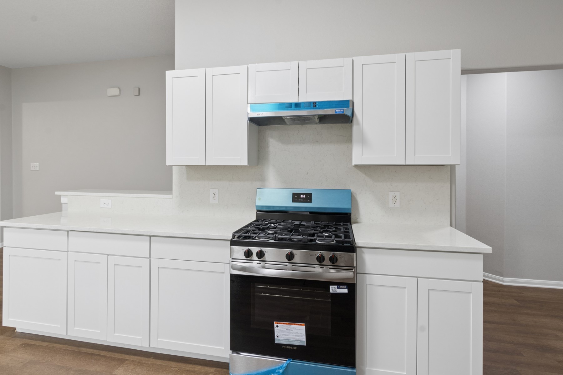 7811 Adonis Avenue Baytown, TX 77521 - Photo 17 of 36 a kitchen with granite countertop white cabinets and white stove