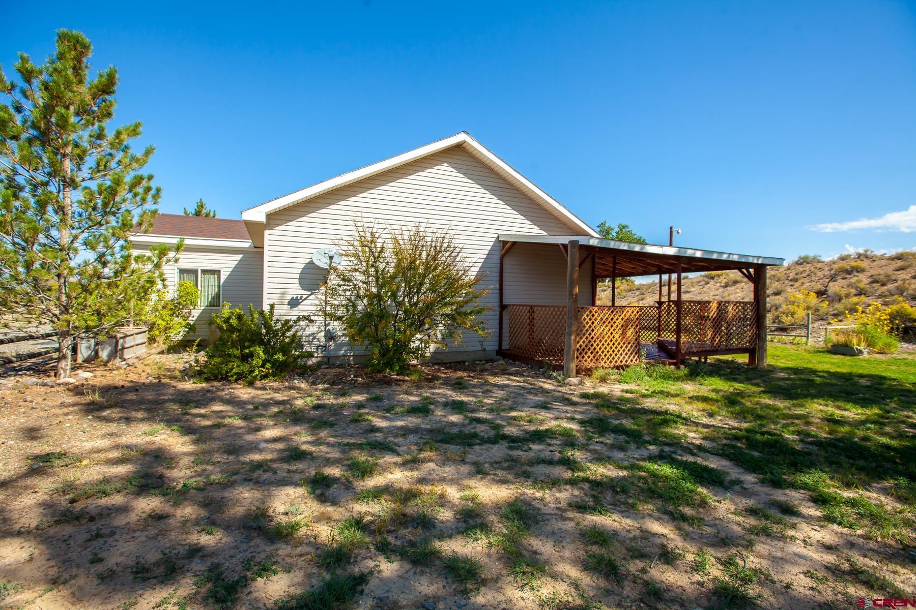 4410 Cedar Road Delta, CO 81416 - Photo 7 of 35 a view of a house with a yard and plants