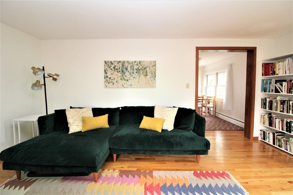 a living room with furniture and a book shelf