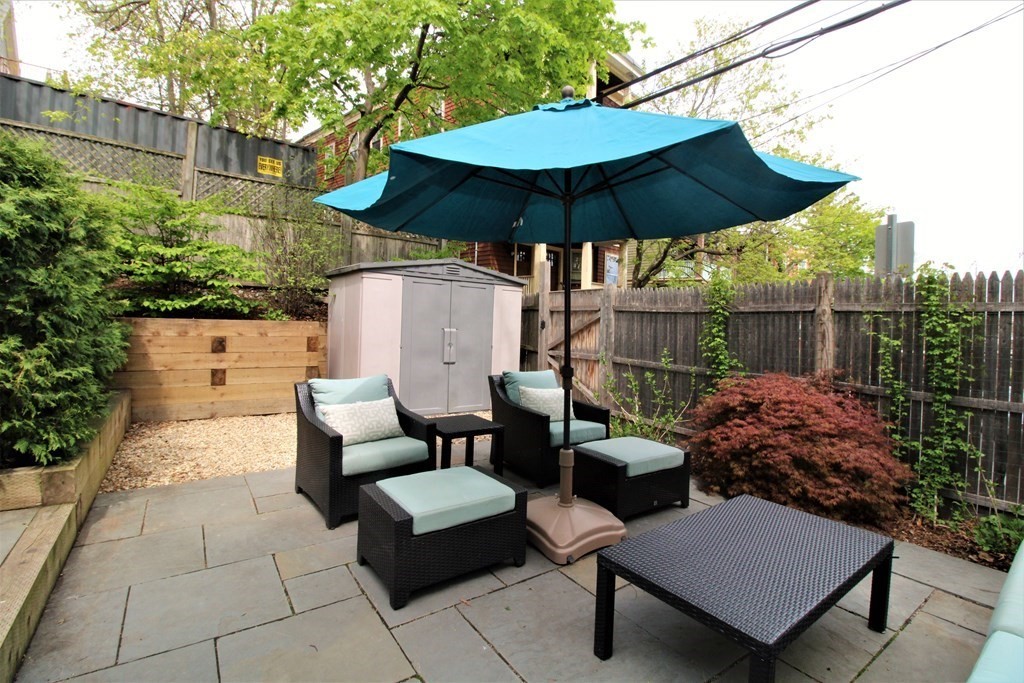 39 Hampstead Road, Unit 1 Boston, MA 02130 - Photo 23 of 29 a view of a patio with furniture and a umbrella