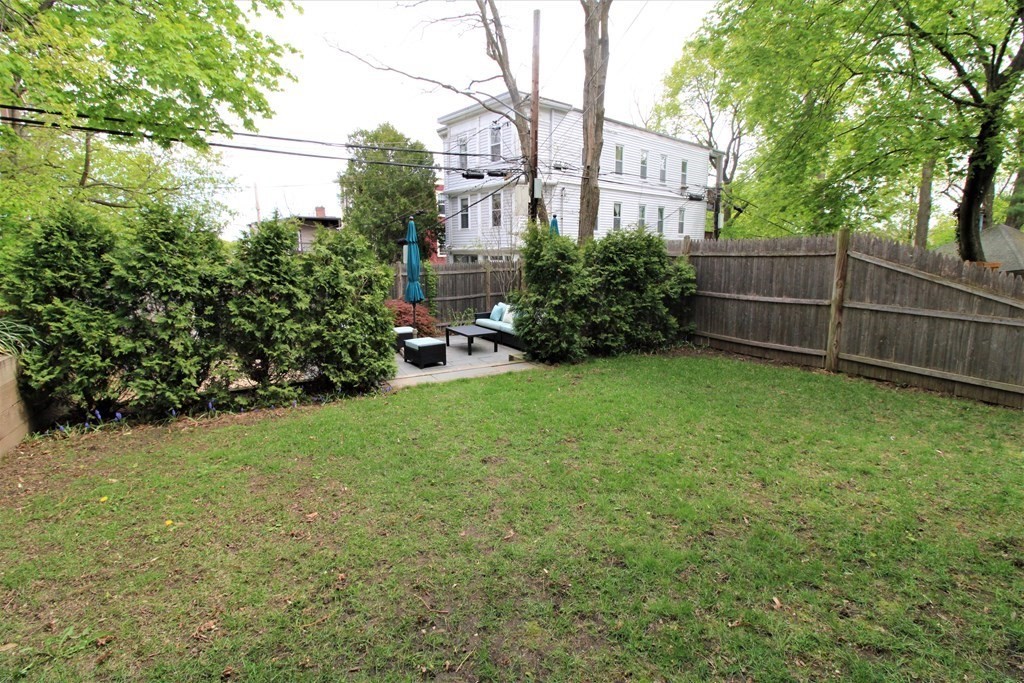 39 Hampstead Road, Unit 1 Boston, MA 02130 - Photo 24 of 29 a view of a backyard with plants and large trees
