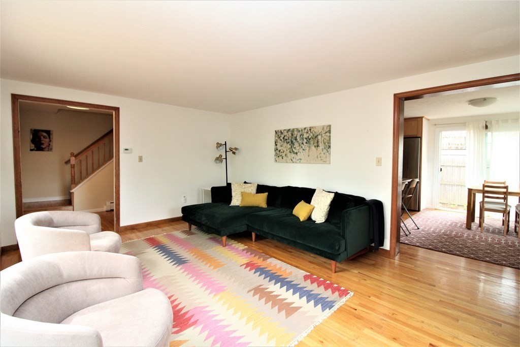 39 Hampstead Road, Unit 1 Boston, MA 02130 - Photo 5 of 29 a living room with furniture and a large mirror with wooden floor