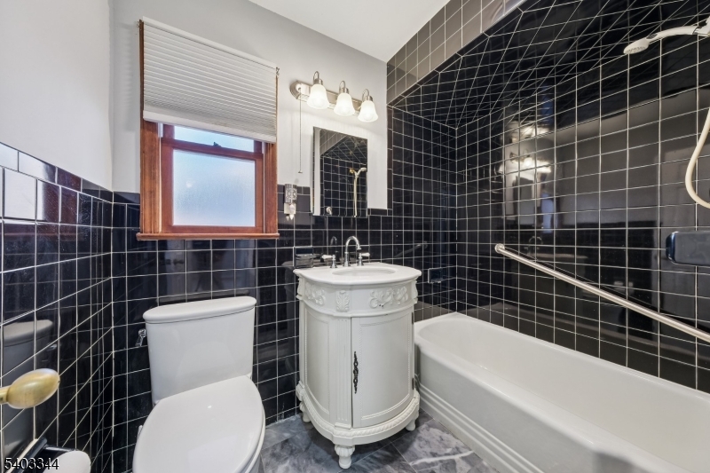 651 Amherst Road Linden, NJ 07036 - Photo 11 of 22 a bathroom with a toilet a sink and mirror