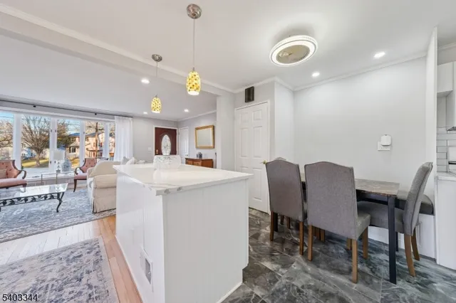 a view of a dining room with furniture and a chandelier