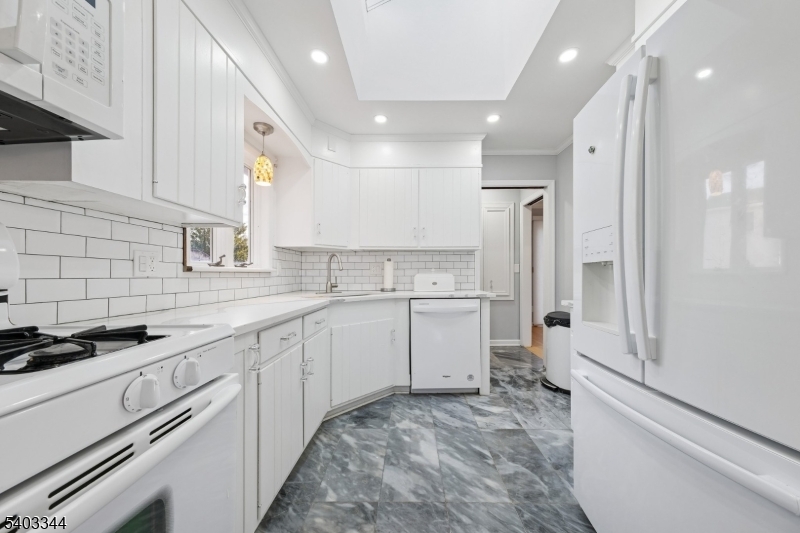 651 Amherst Road Linden, NJ 07036 - Photo 13 of 22 a kitchen with a sink stove and cabinets