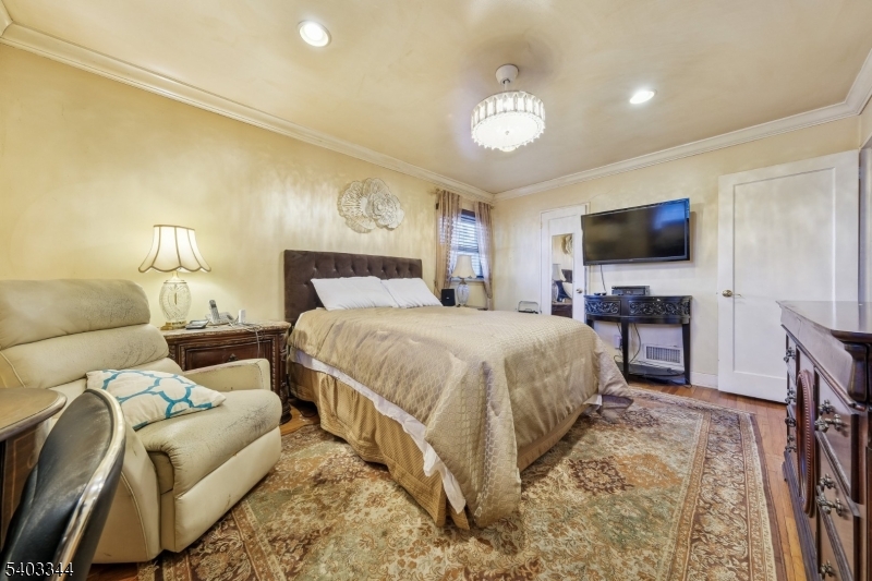 651 Amherst Road Linden, NJ 07036 - Photo 15 of 22 a bedroom with a bed and a flat screen tv