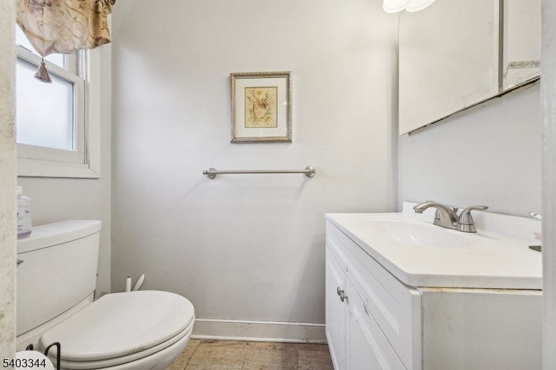 651 Amherst Road Linden, NJ 07036 - Photo 16 of 22 a bathroom with a granite countertop toilet sink and mirror
