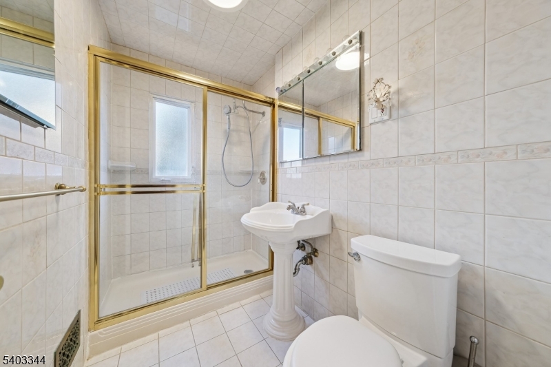 651 Amherst Road Linden, NJ 07036 - Photo 17 of 22 a bathroom with a sink a toilet and shower