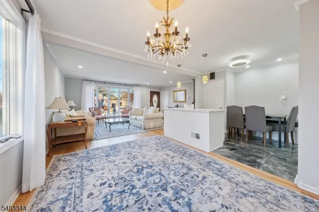 a living room with furniture and a dining table