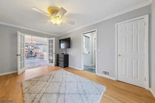 a bedroom with a bed and a chandelier