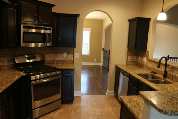 a kitchen with a stove and a microwave