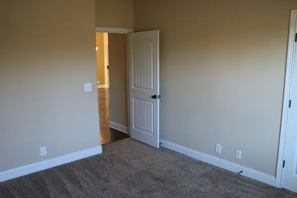 an empty room with closet area