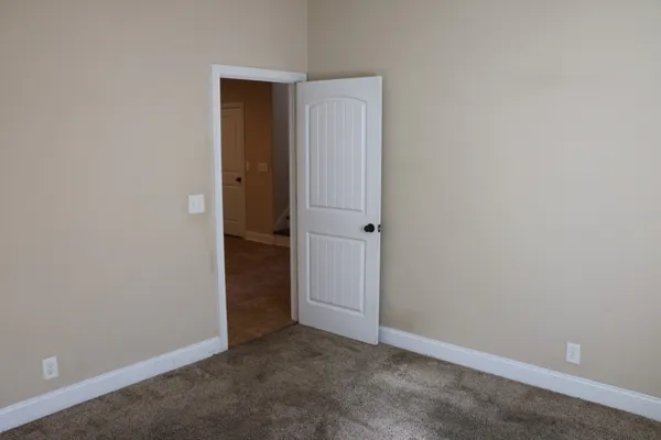 an empty room with closet area