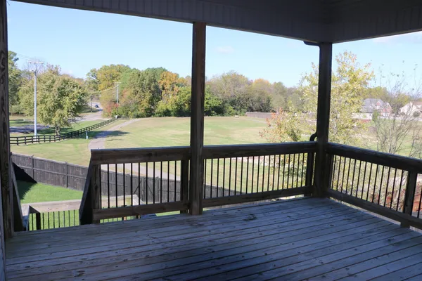 a view of balcony with wooden floor