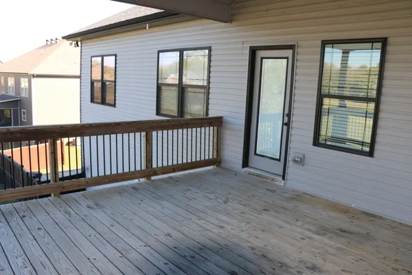 a view of a house with wooden deck