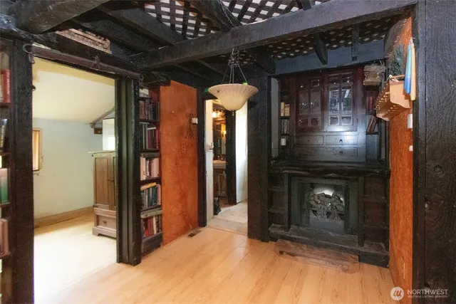 a view of a hallway with wooden floor and entryway