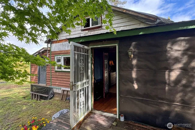a view of a patio with table and chairs with wooden floor and fence