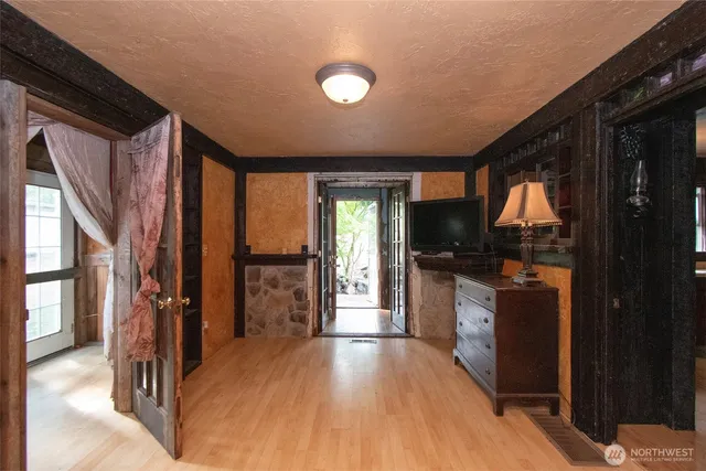 a view of hallway with wooden floor and windows
