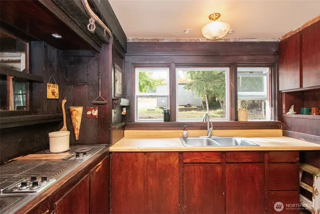 a kitchen with a sink and large window